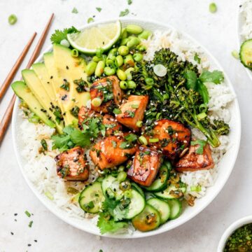 close up shot of salmon rice bowls with crispy broccoli and avocado.