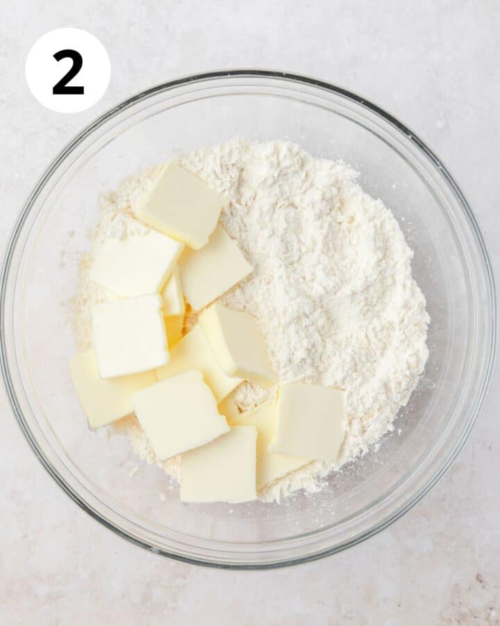 adding cold butter to parmesan pie crust.