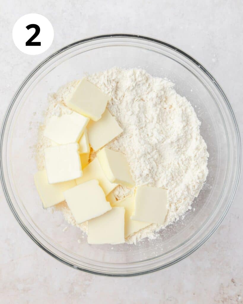 adding cold butter to parmesan pie crust.