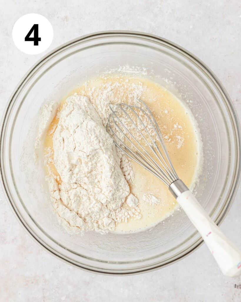 adding dry ingredients to cupcake batter.