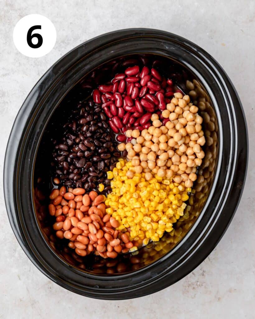 adding beans and corn to slow cooker.