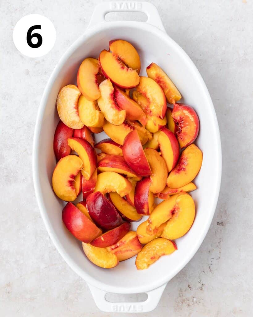 sliced peaches in baking dish.