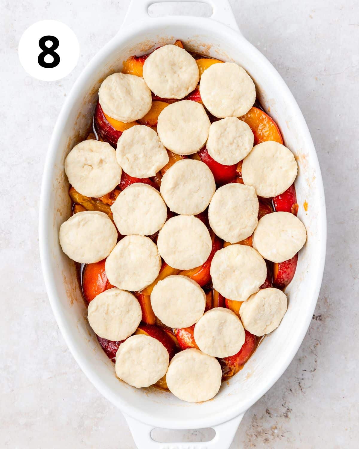 peaches covered with mini round biscuits.