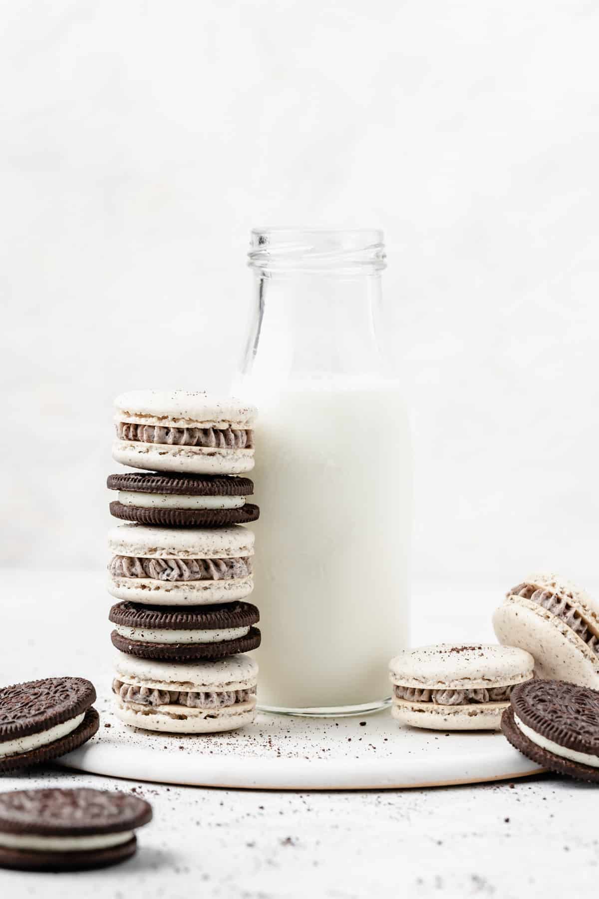 stack of oreo macarons and bottle of milk.