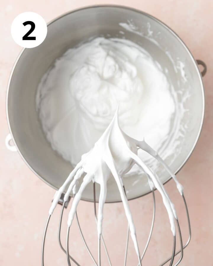 whipping meringue to stiff peaks.