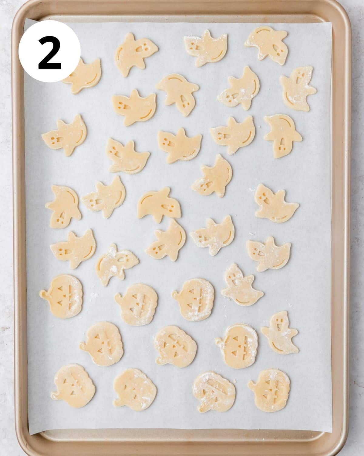 arranging pie crust cutouts on baking sheet.