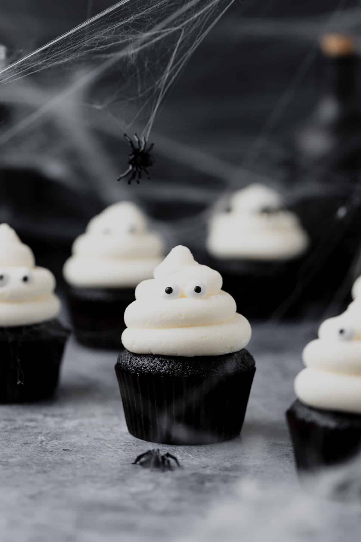 black velvet ghost cupcakes with cream cheese frosting.