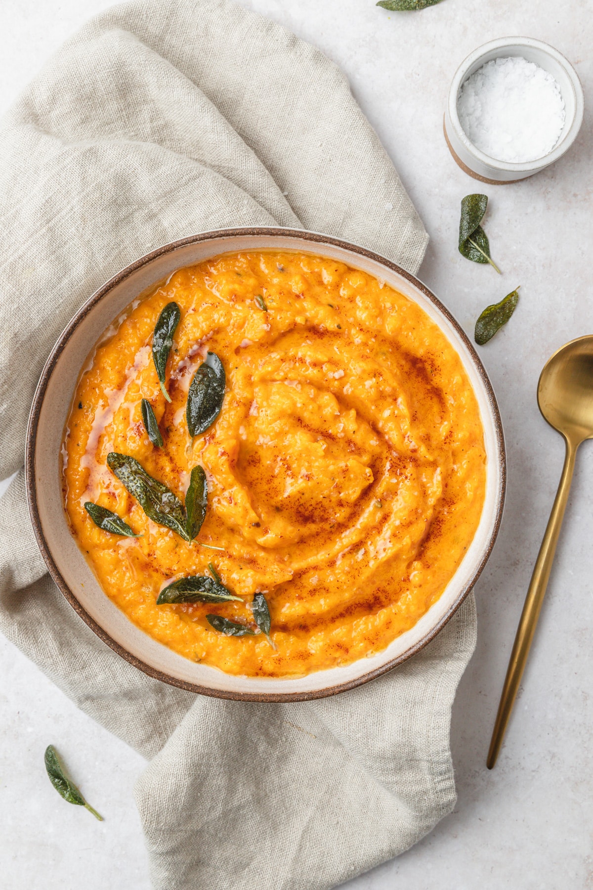 bowl of mashed butternut squash with brown butter and crispy sage.