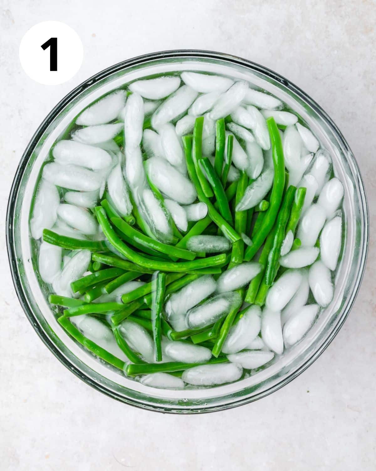 blanched green beans in ice water.