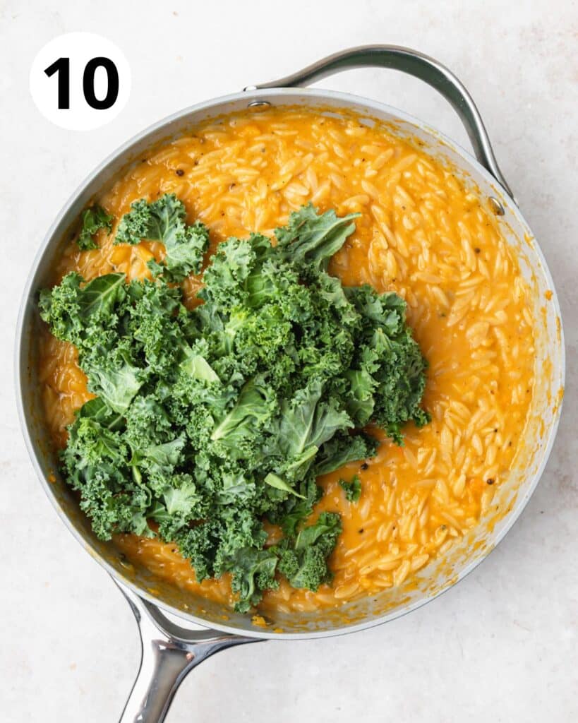 adding kale to cooked orzo.