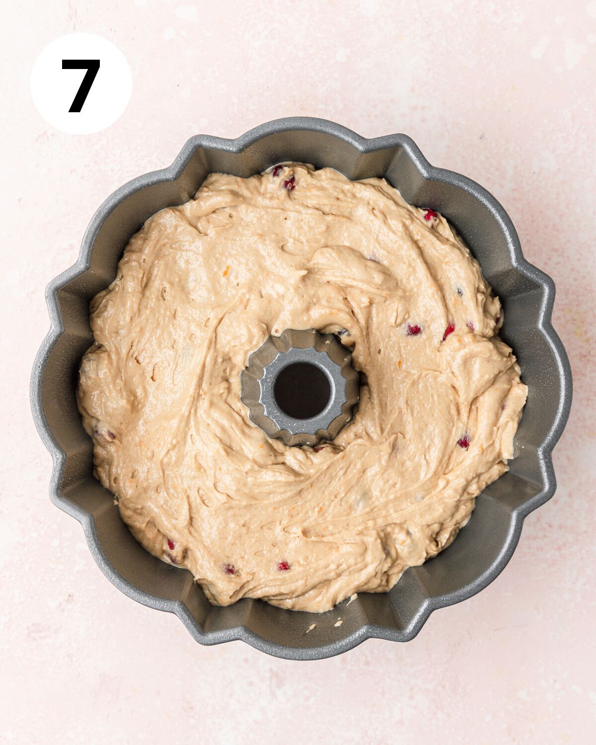 cranberry cake batter in bundt pan before baking.