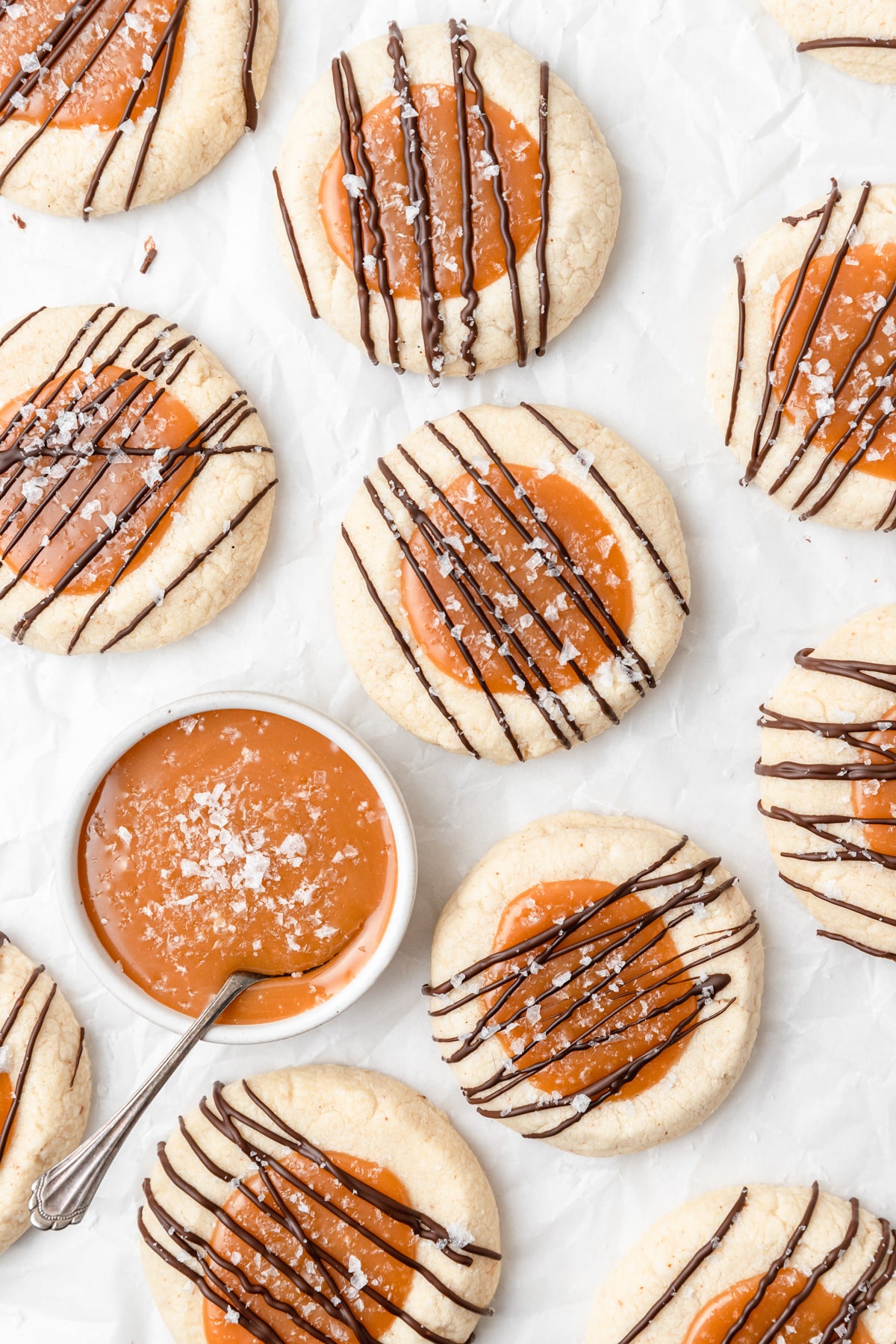 brown butter caramel filled thumbprint cookies with chocolate drizzle.