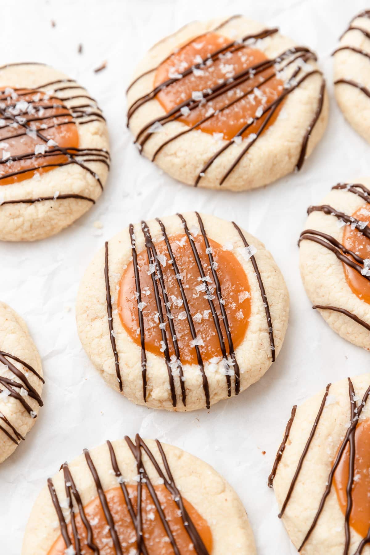 caramel cookies with dark chocolate drizzle on top.