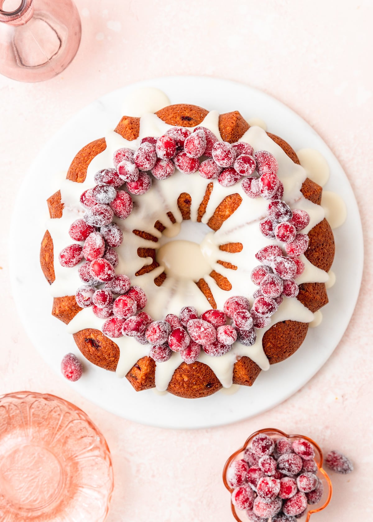 top view of cranberry bundt cake topped with sugared cranberries.