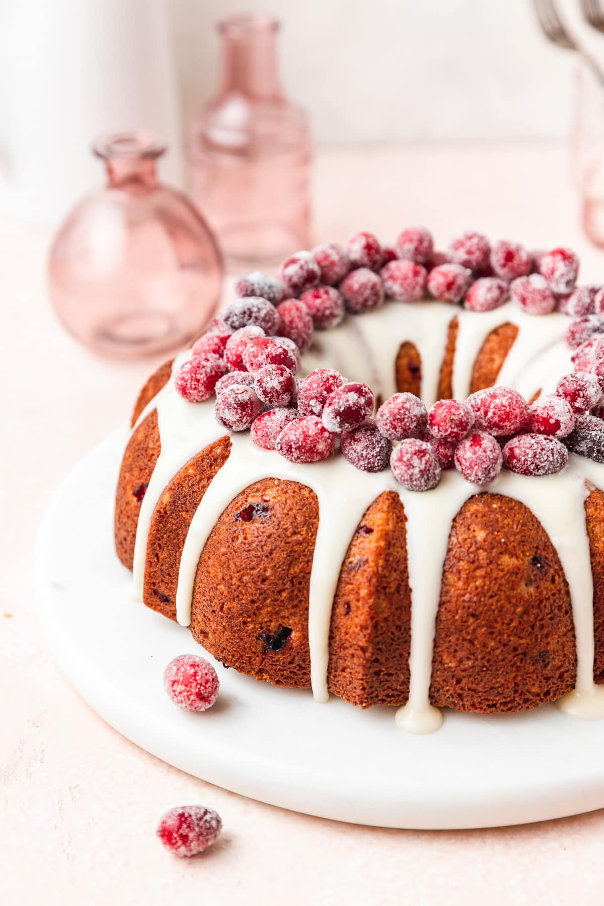cranberry bundt cake topped with candied cranberries.