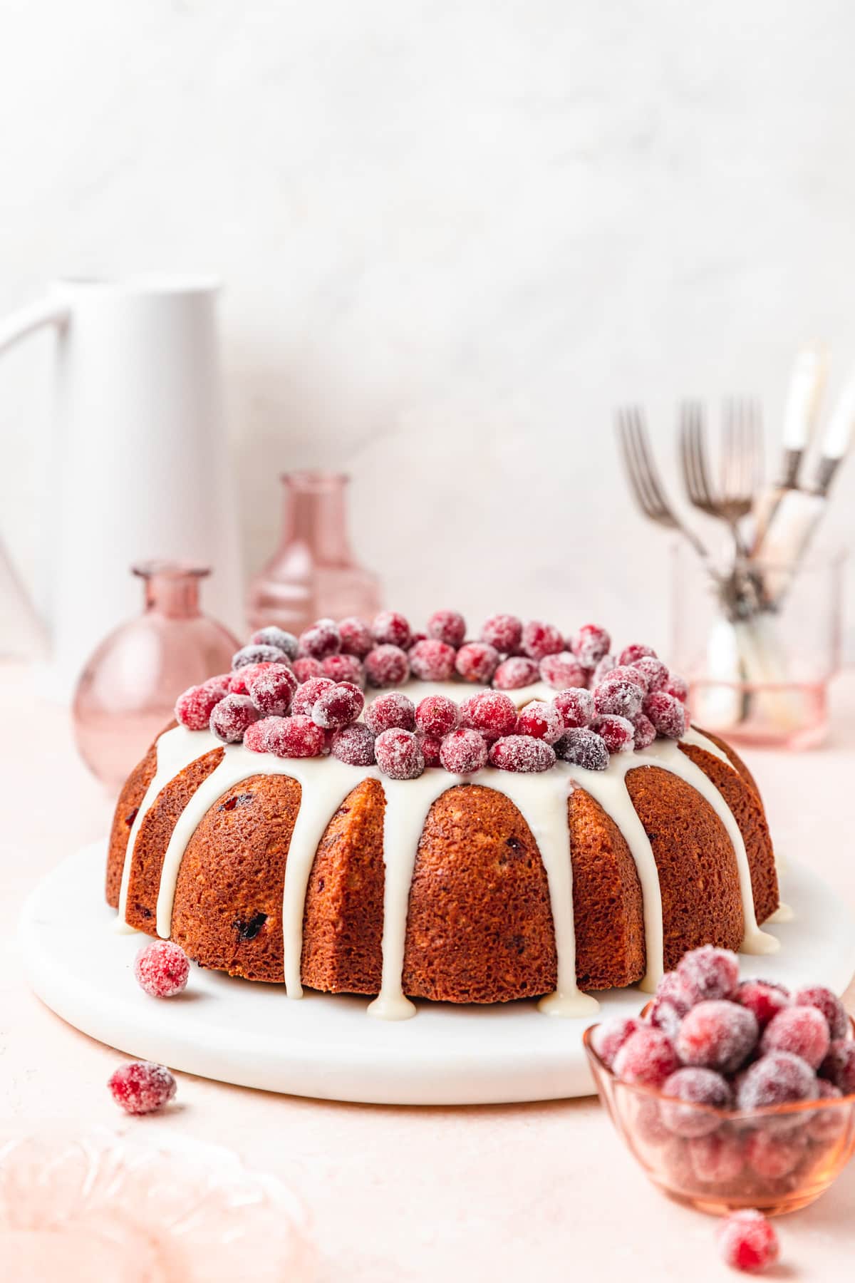 cranberry bundt cake with sugared cranberries on top.