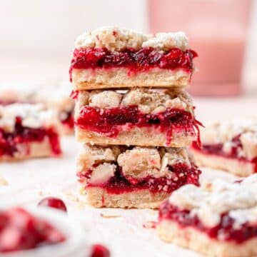close up shot of stack of cranberry crumble bars.