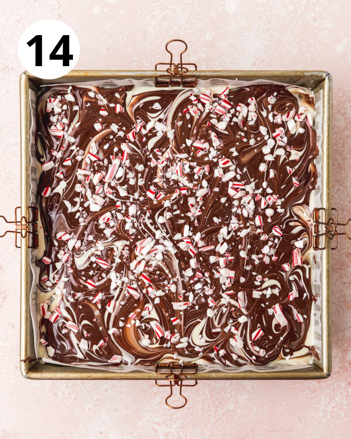 sprinkling crushed candy canes over peppermint bark brownies.