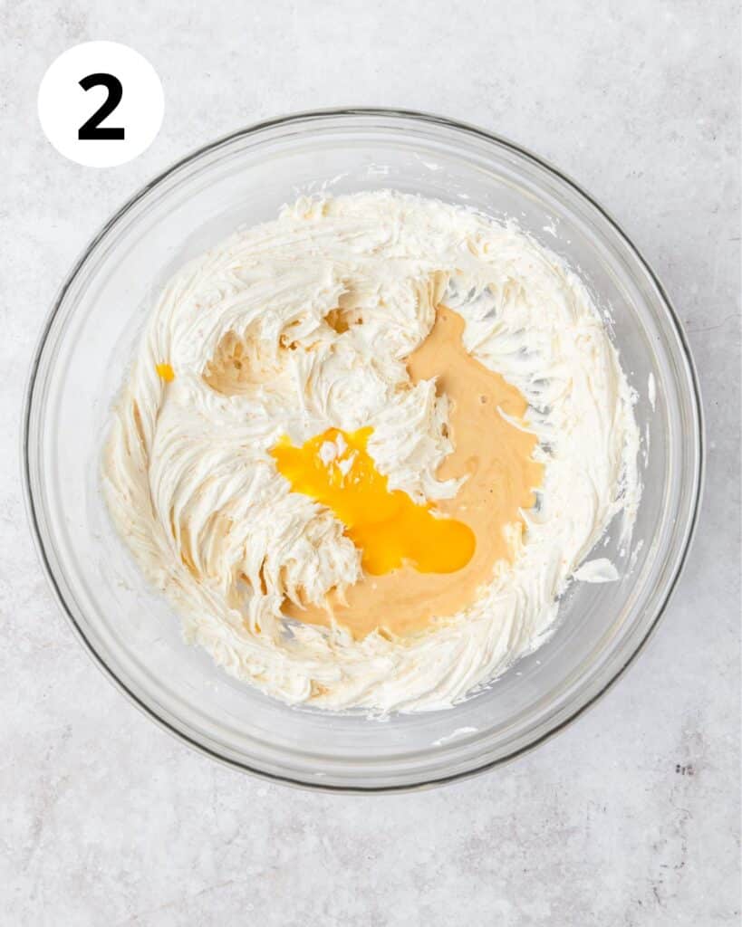 adding egg yolk and eggnog to cookie dough.