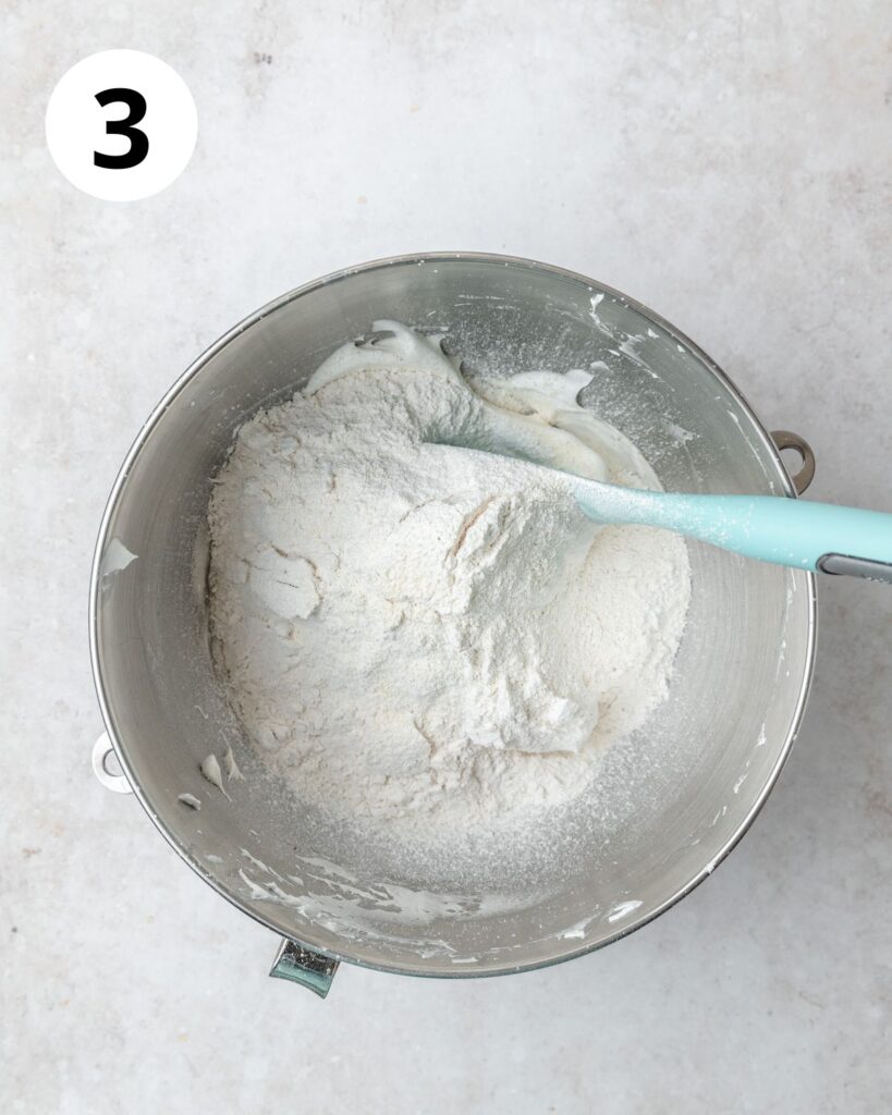 adding dry ingredients to macaron batter.