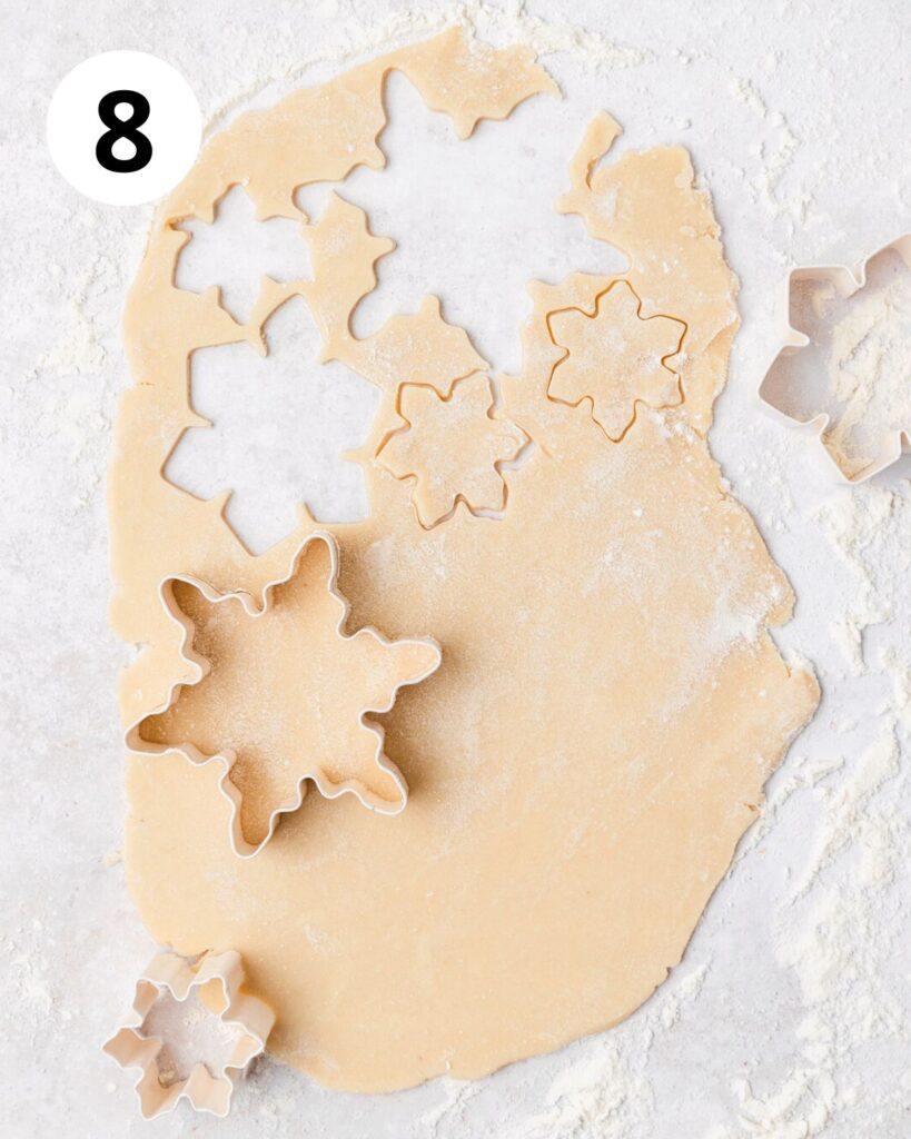 cutting out shortbread snowflake shapes.