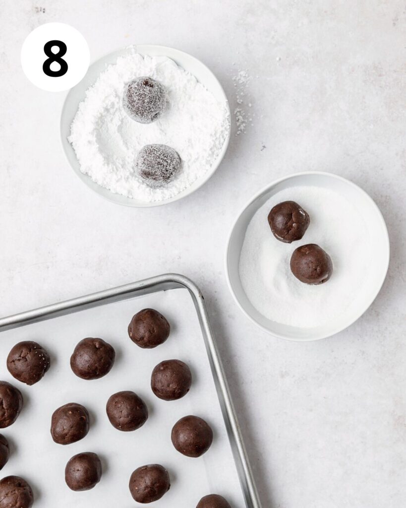 rolling chocolate dough balls in granulated sugar then in powdered sugar.