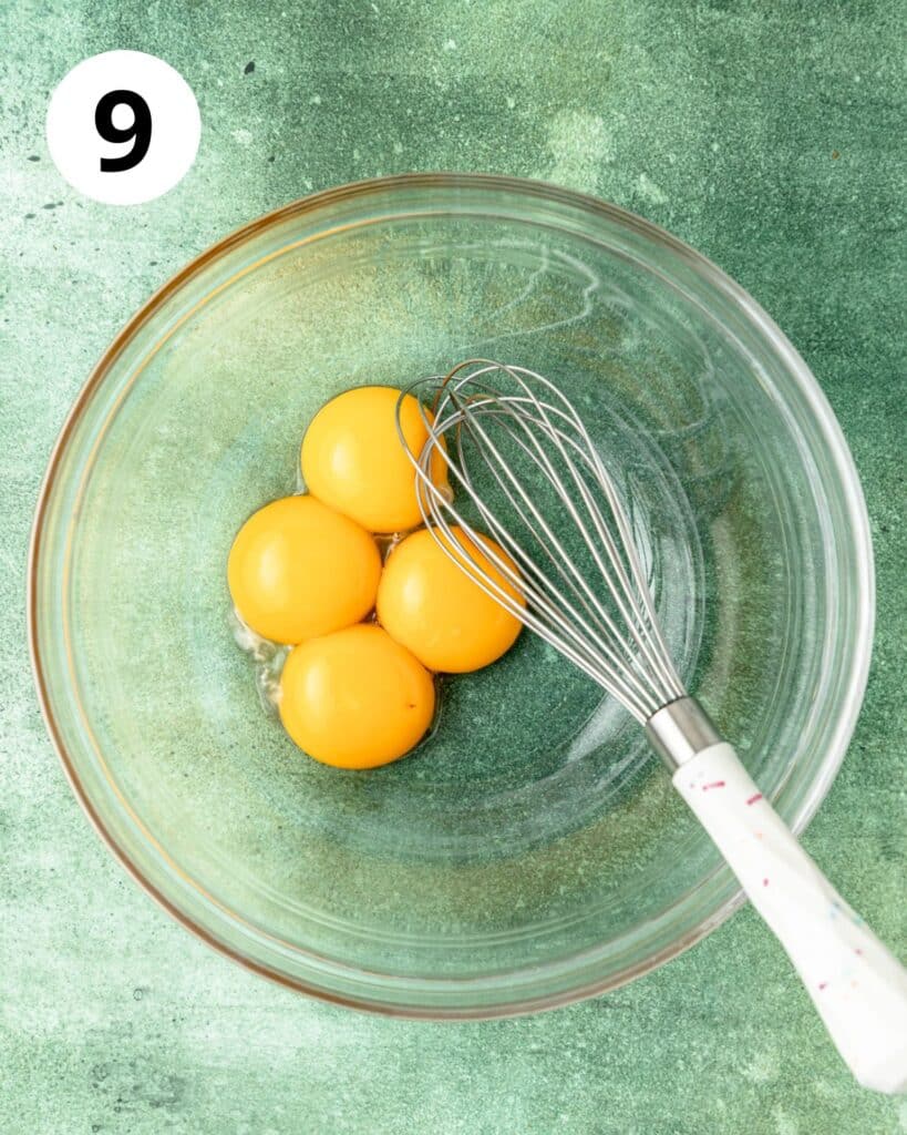 whisking egg yolks in bowl.