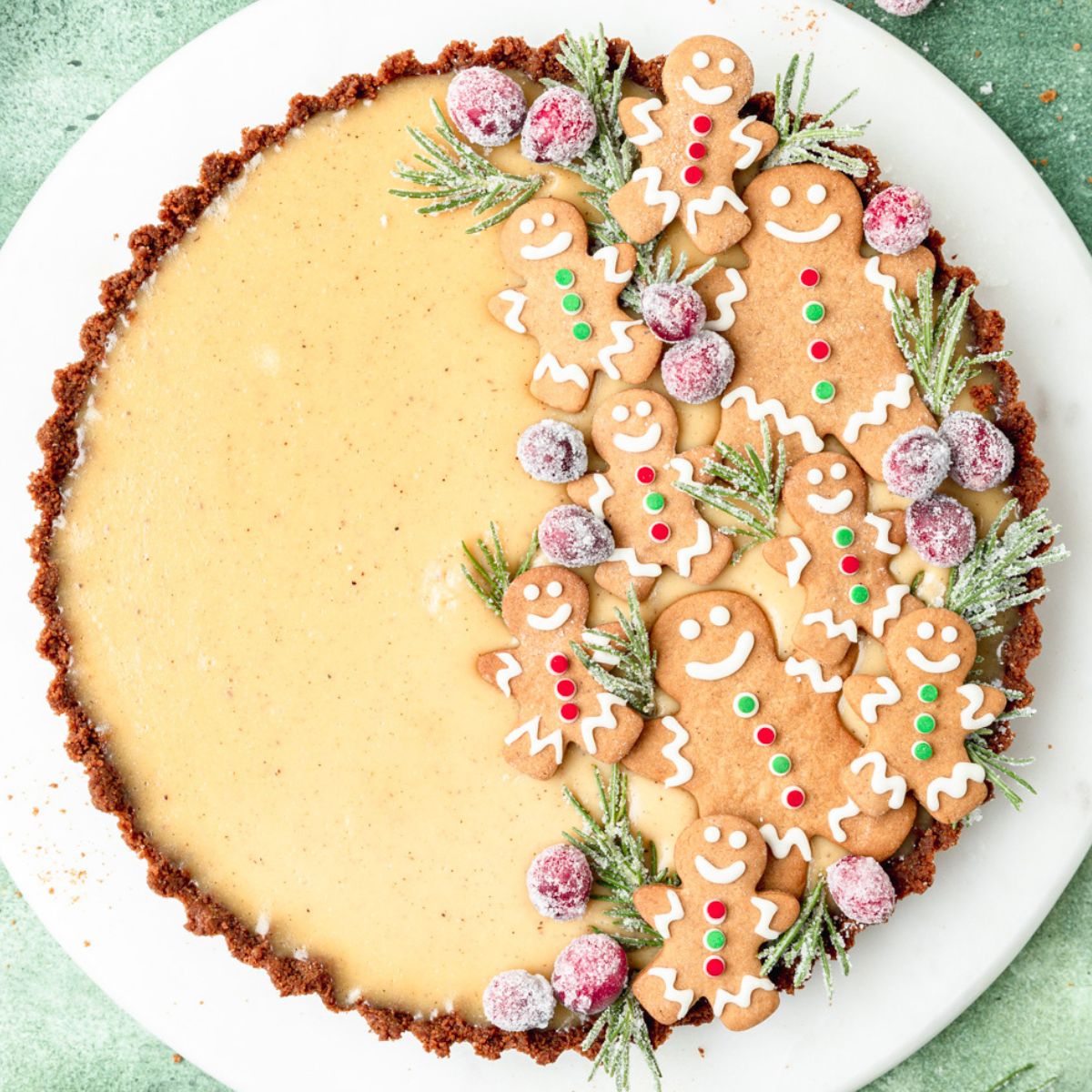 close up shot of eggnog custard tart topped with gingerbread cookies.