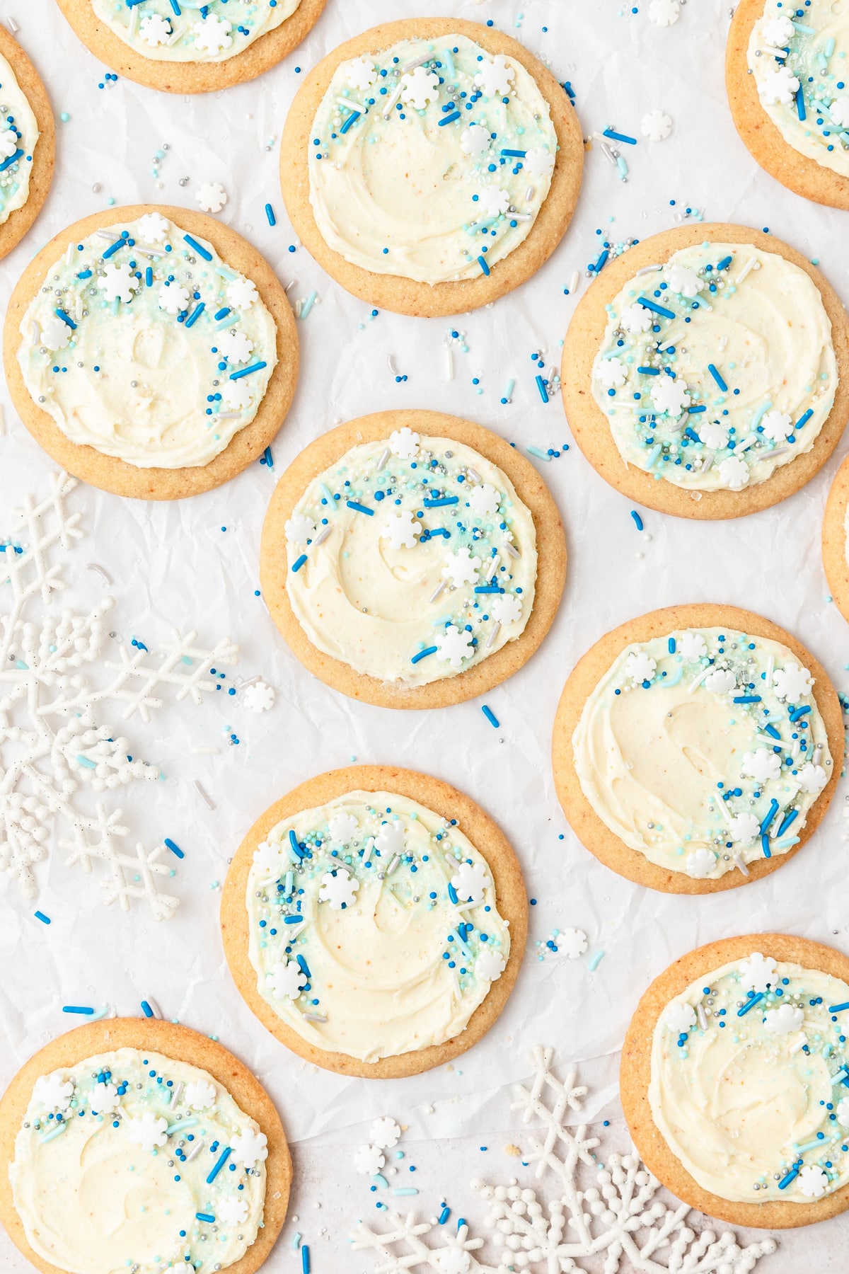 brown butter frosted eggnog cookies with snowflake sprinkles.