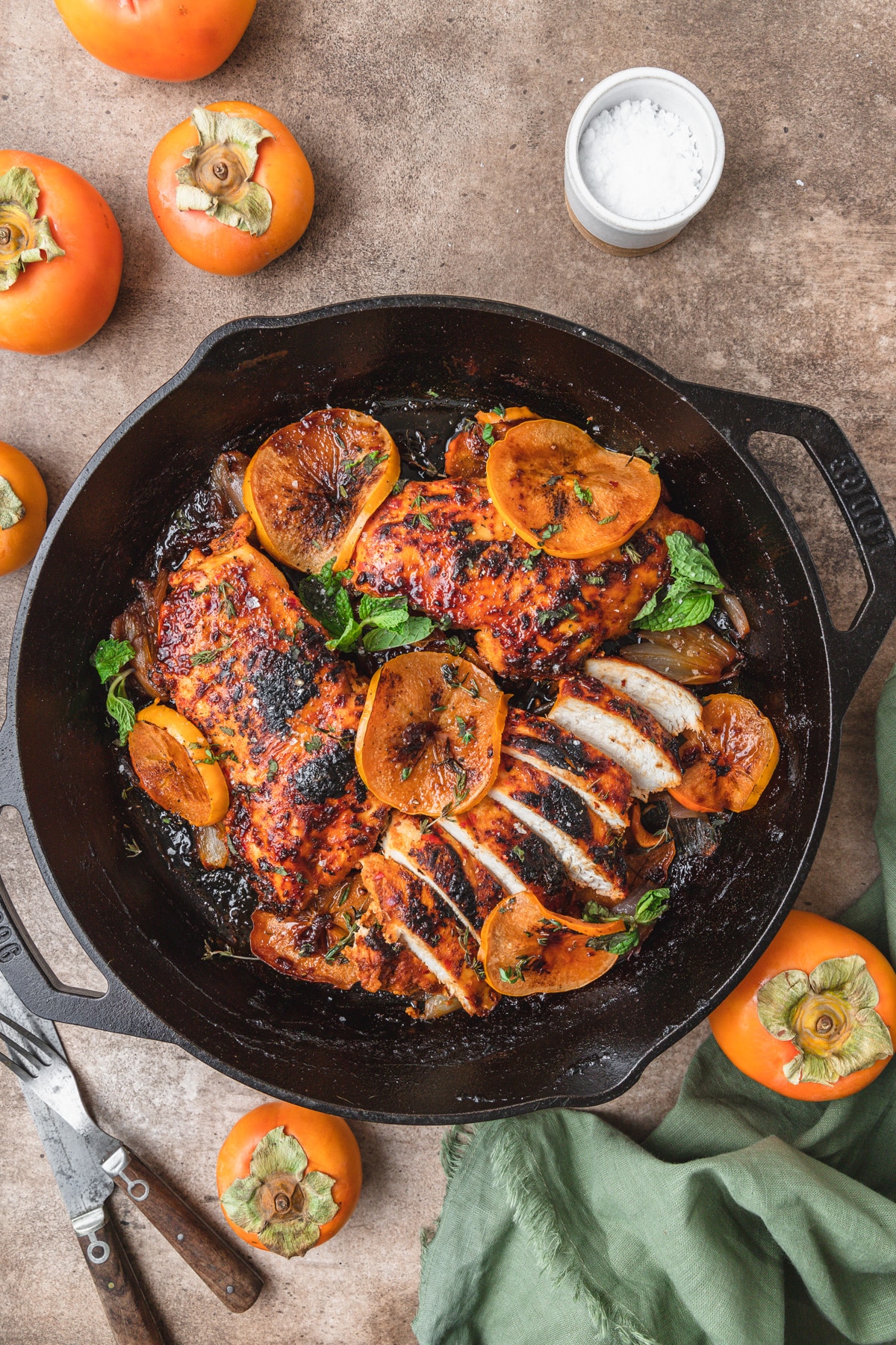 harissa and persimmon chicken breasts in skillet.