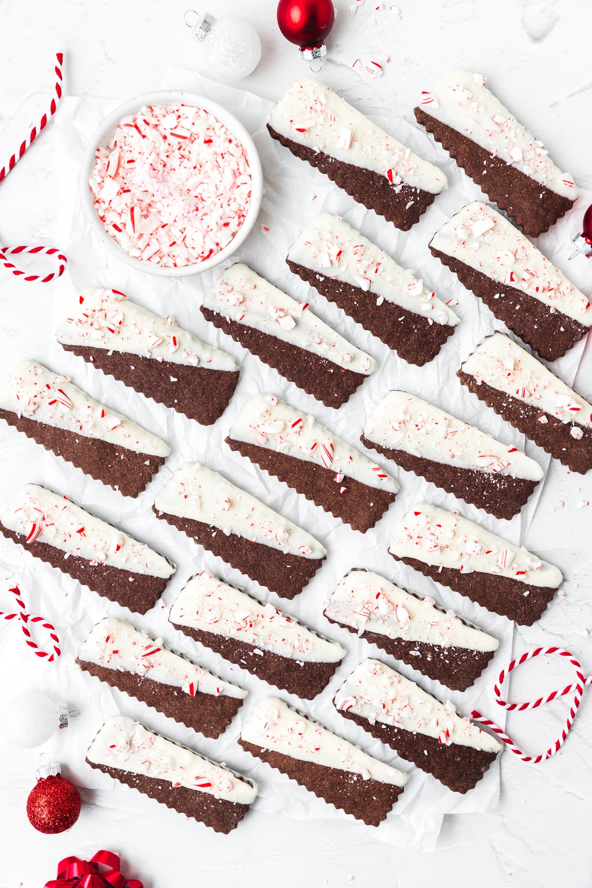 chocolate peppermint shortbread cookies dipped in white chocolate with crushed candy canes.