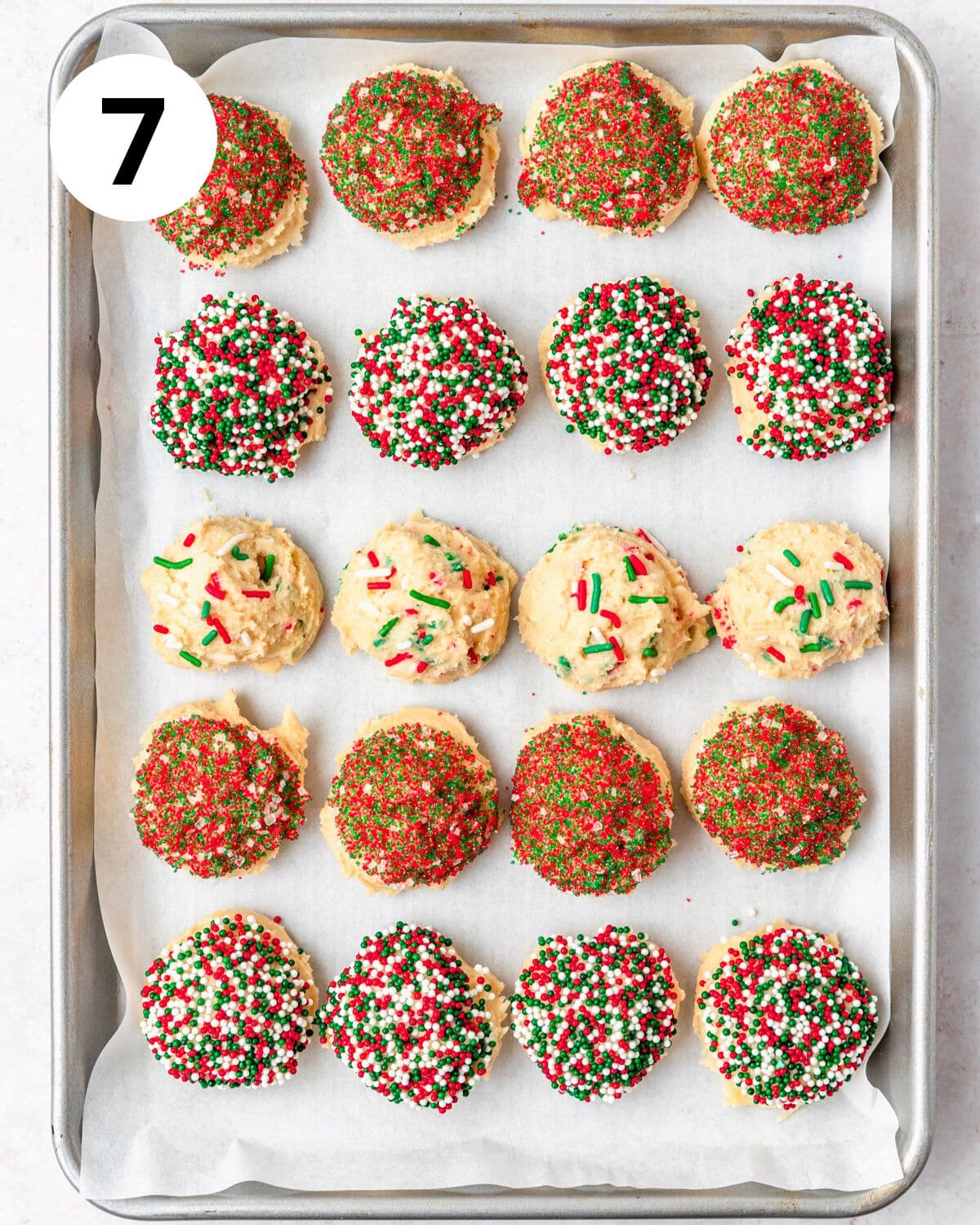 sugar cookies rolled in different types of christmas sprinkles.
