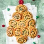 close up shot of christmas tree shaped spinach artichoke rolls.