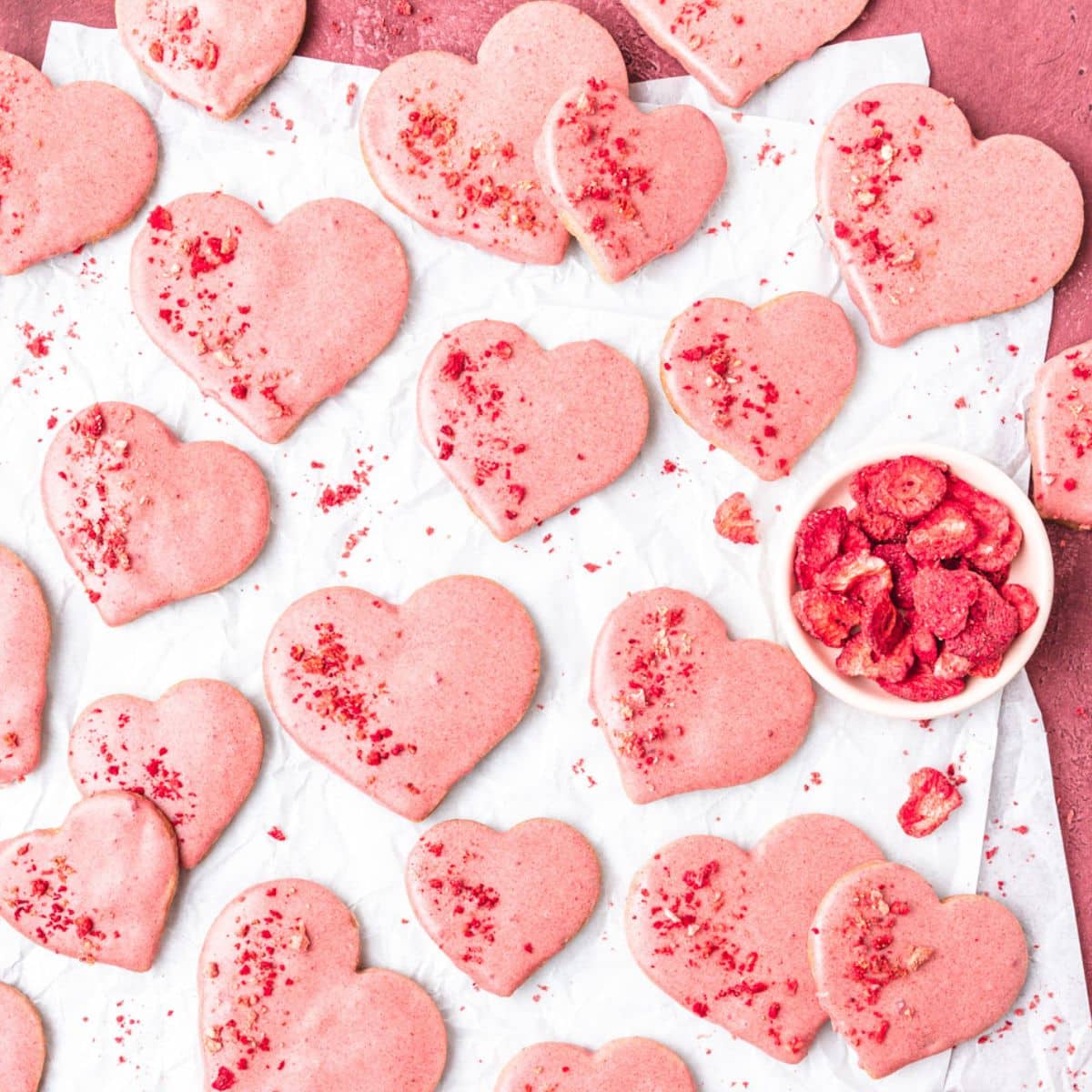 close up shot of heart shaped strawberry shortbread cookies.
