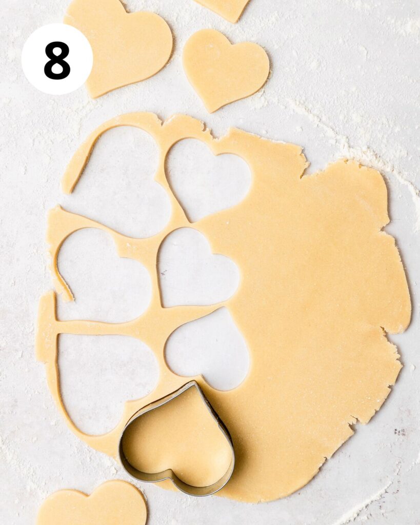 cutting hearts out of sugar cookie dough.