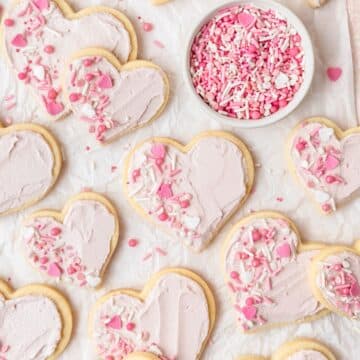 close up shot of frosted sugar cookies shaped like hearts.
