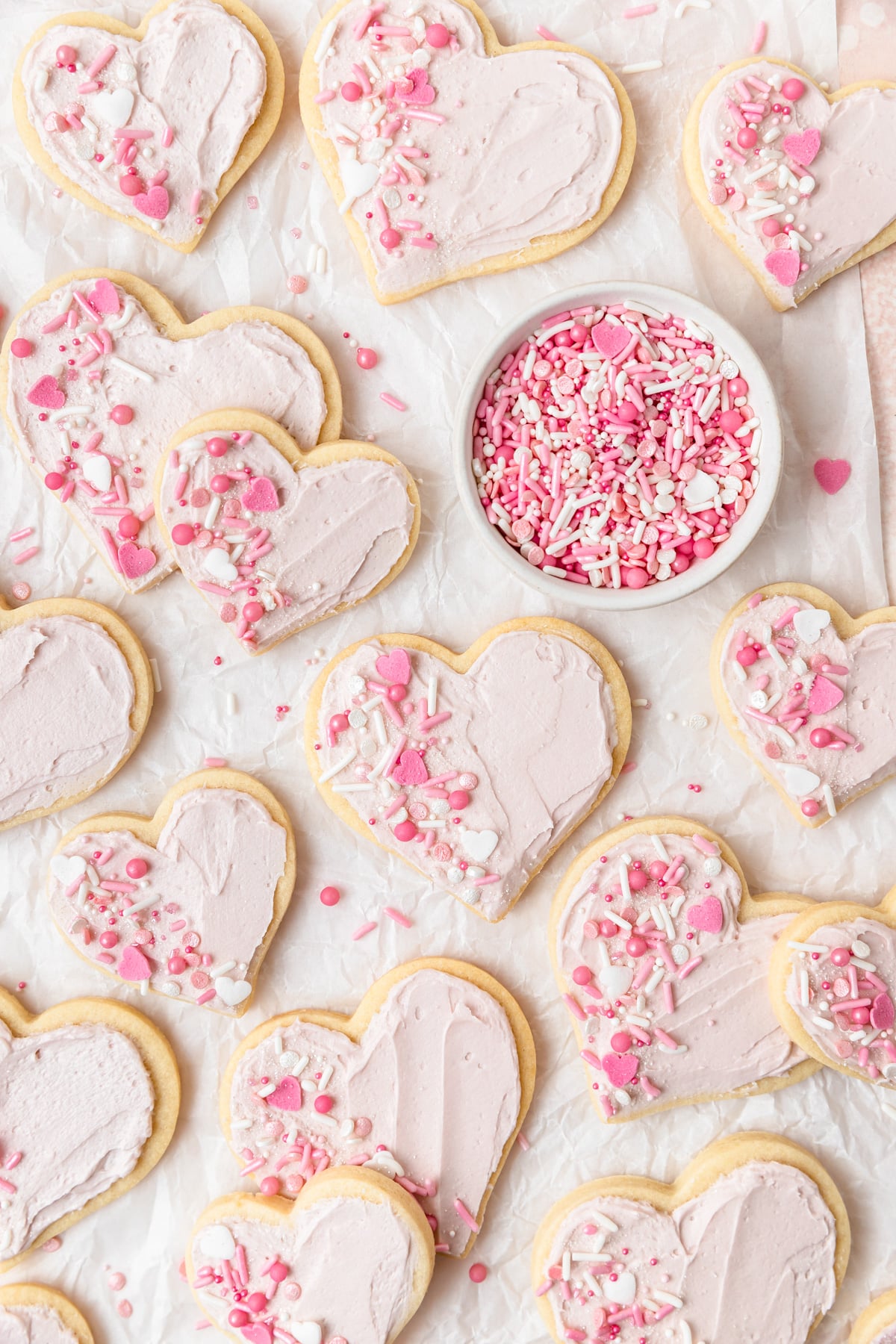 frosted sugar cookies with Valentine's day sprinkles.