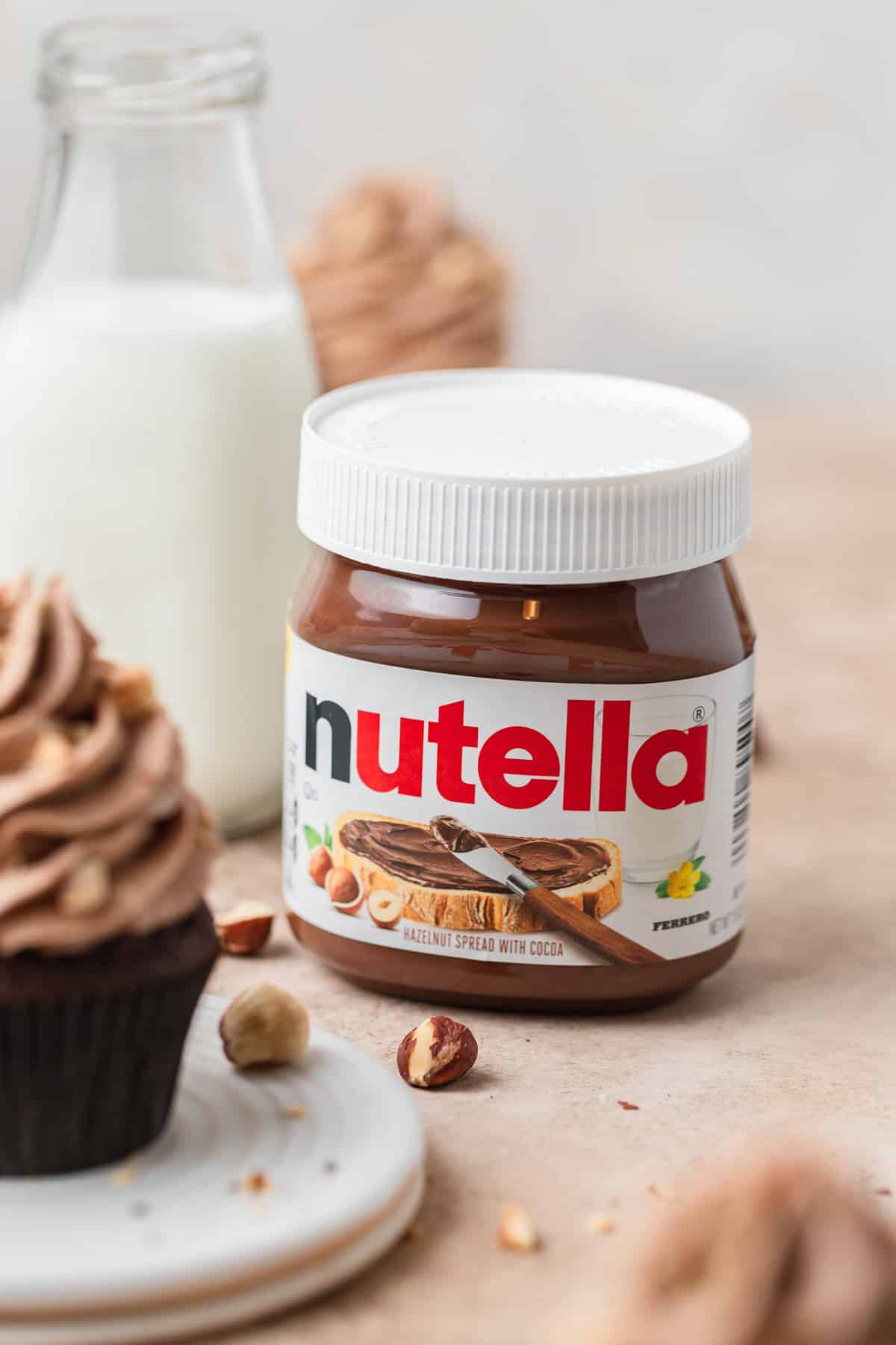 jar of Nutella with chocolate cupcakes.