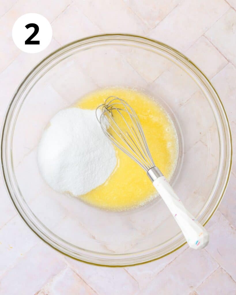 whisking melted butter and sugar.