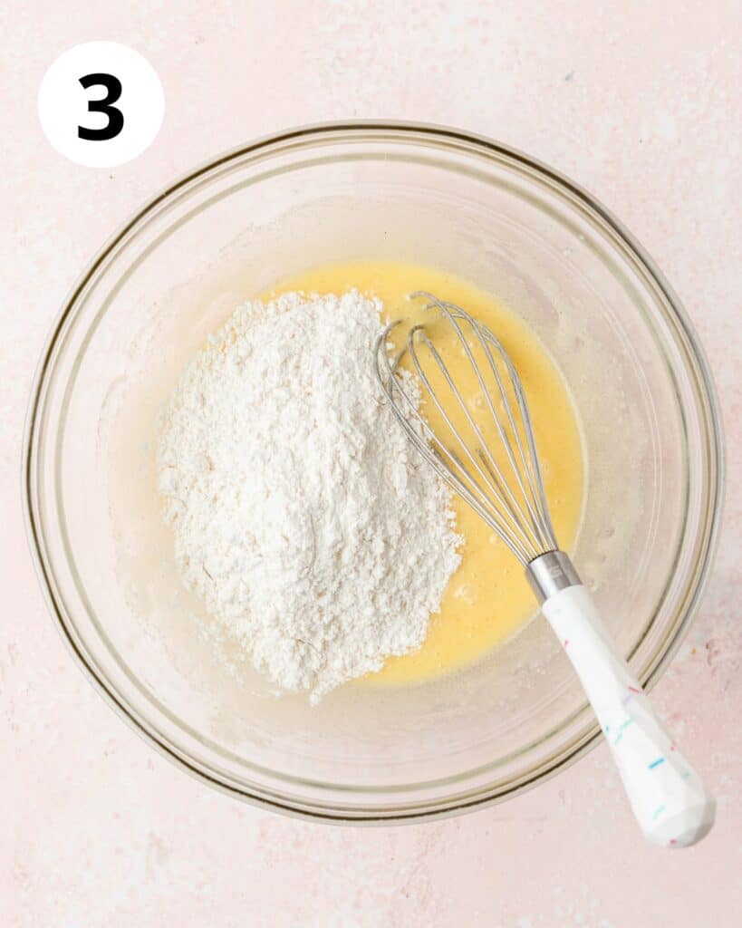 adding flour to cupcake batter.