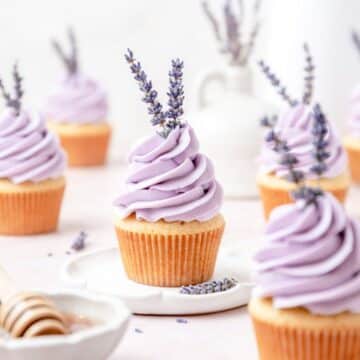 close up shot of honey lavender cupcakes with lavender flowers.