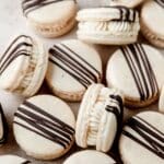 close up of Bailey's Irish cream macarons with chocolate drizzle.