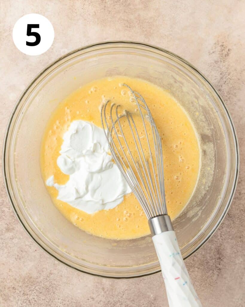 adding sour cream to cake batter.