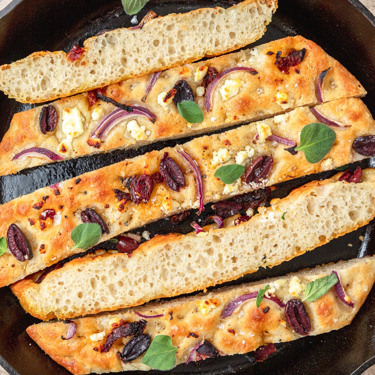sundried tomato and olive focaccia cut into slices.