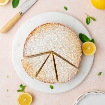 close up shot of lemon ricotta cake topped with powdered sugar.