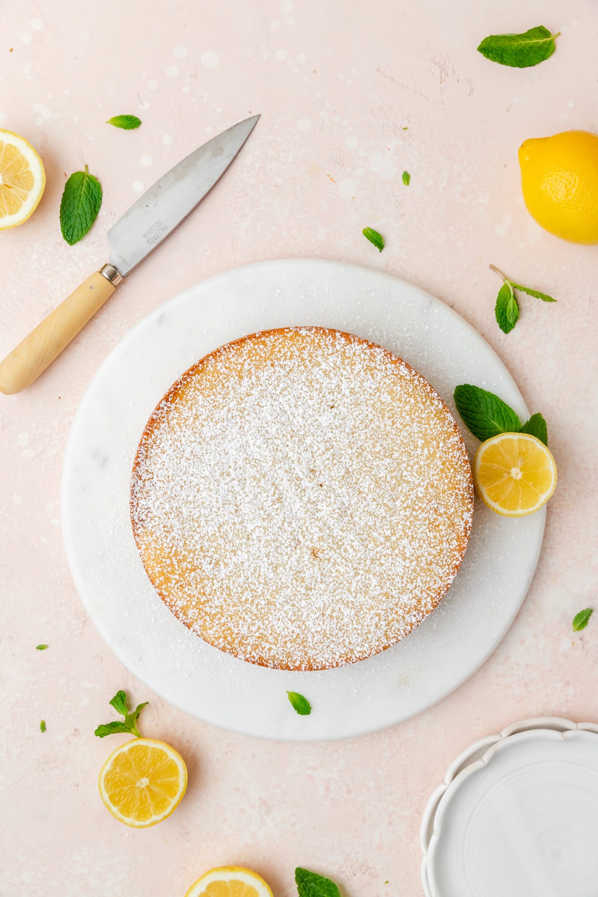 lemon ricotta cake on cake stand.