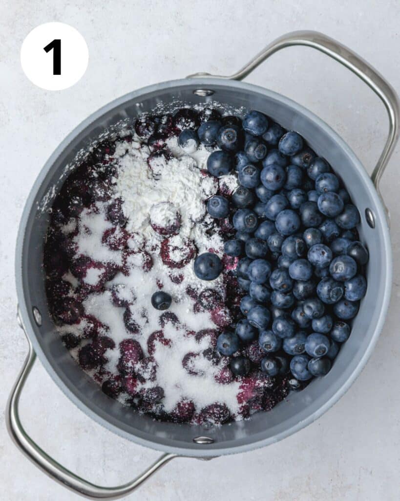 blueberries sugar and cornstarch in pot.