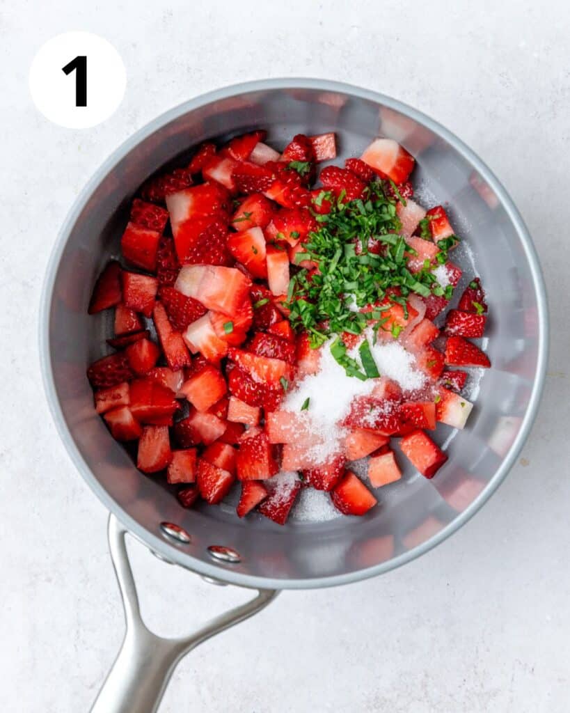 strawberries basil and sugar in pot.