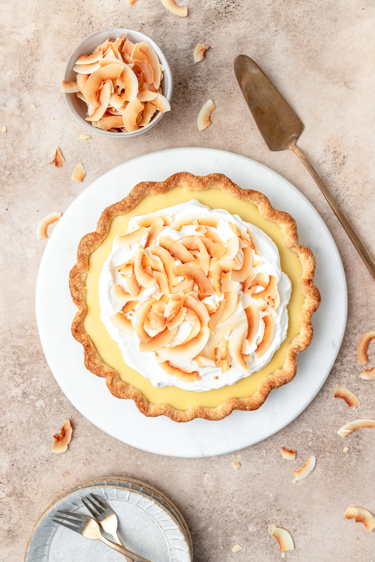 coconut cream pie topped with whipped cream and toasted coconut.