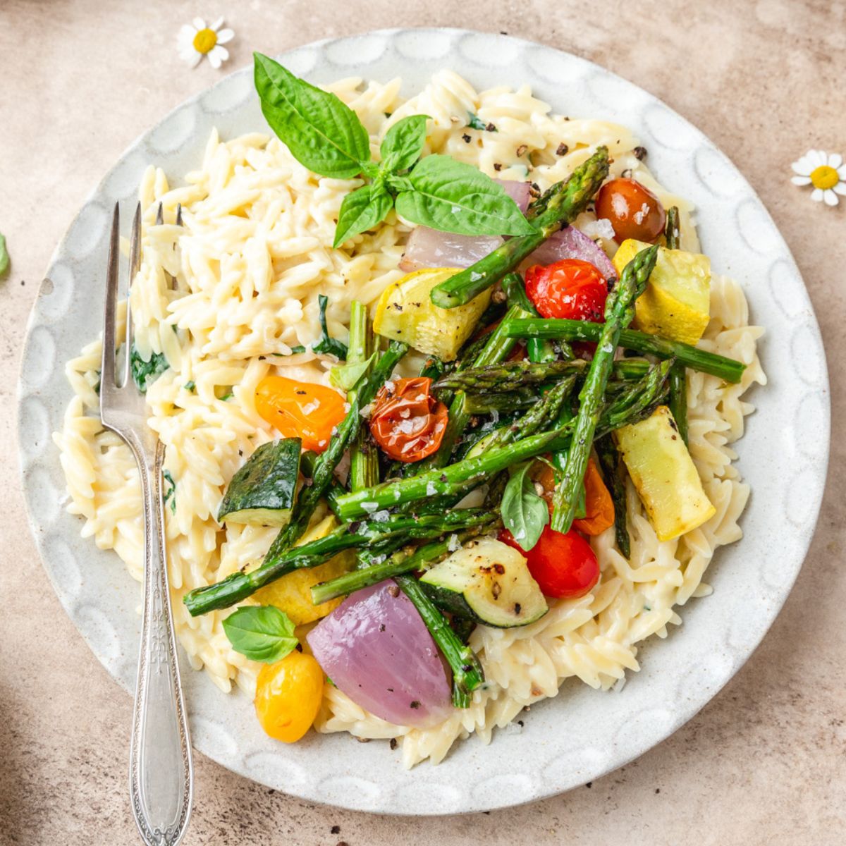 close up shot of creamy orzo with roasted summer vegetables.